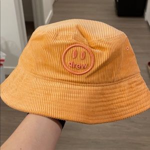 drew house orange corduroy bucket hat with pink logo
